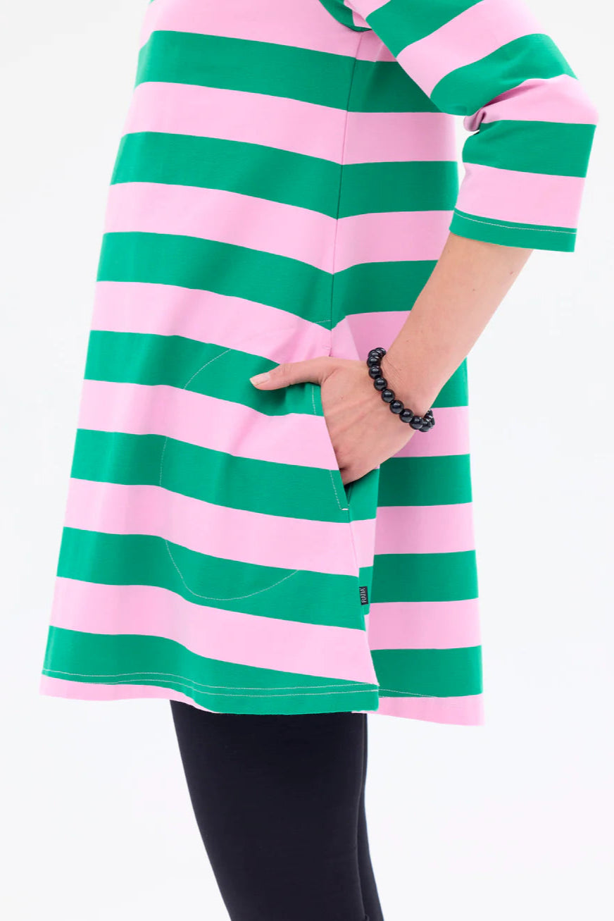 Green and pink striped dress worn by a person on a white background