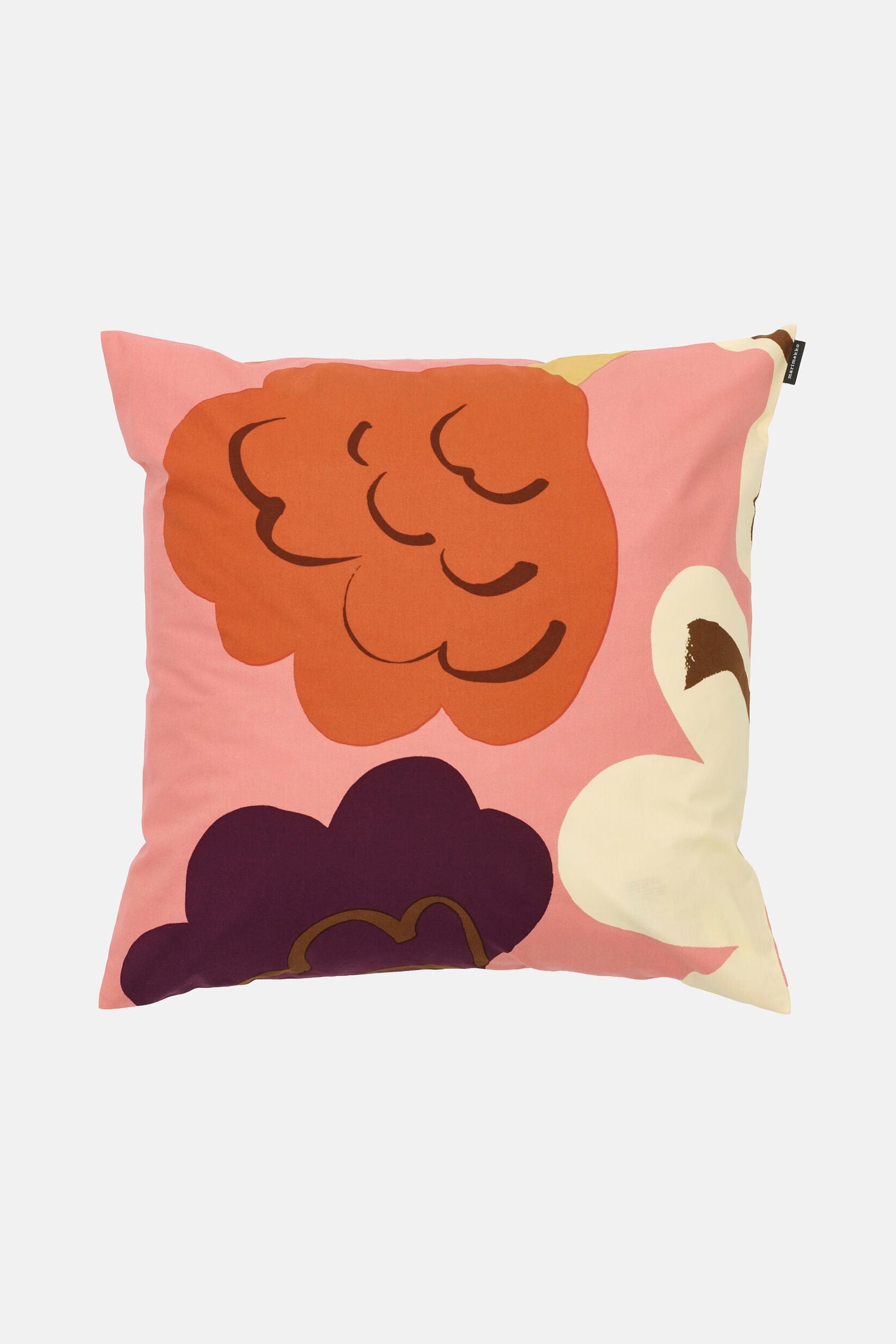 Decorative pillow with abstract designs on a light pink background