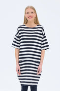Woman wearing a black and white striped dress on a white background