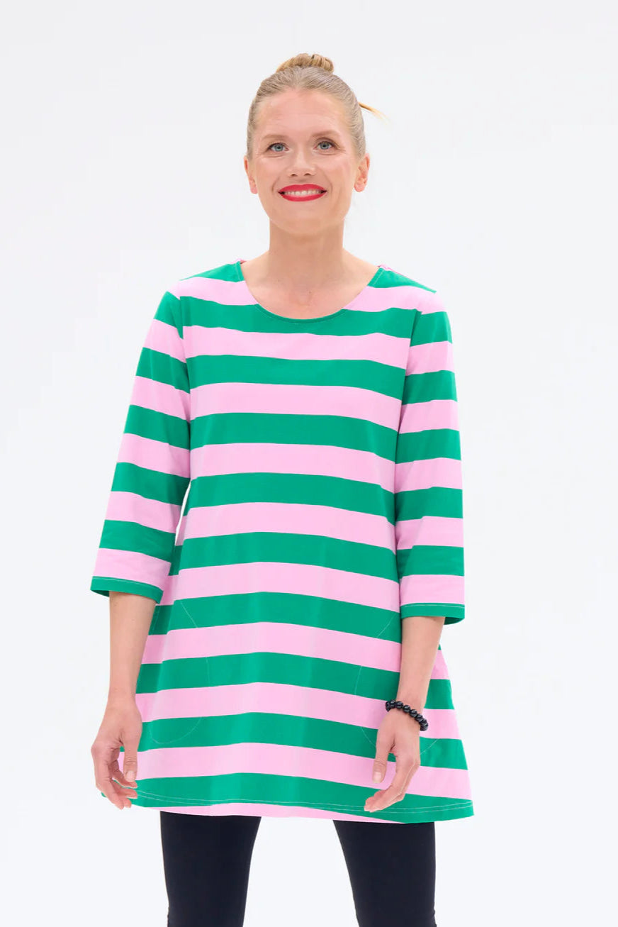 Woman wearing a green and pink striped dress on a white background