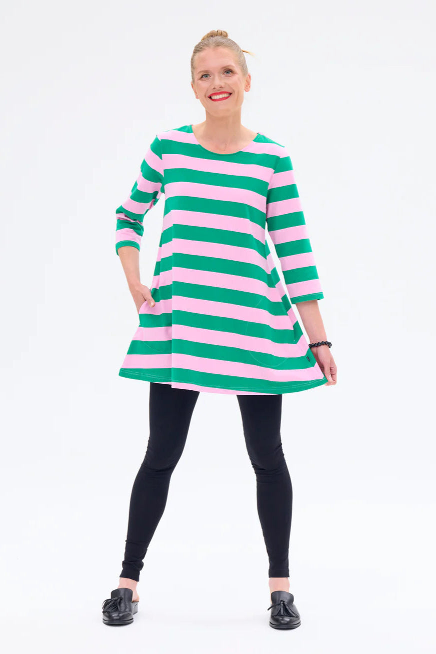 Woman wearing a green and pink striped dress on a white background