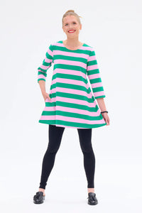 Woman wearing a green and pink striped dress on a white background