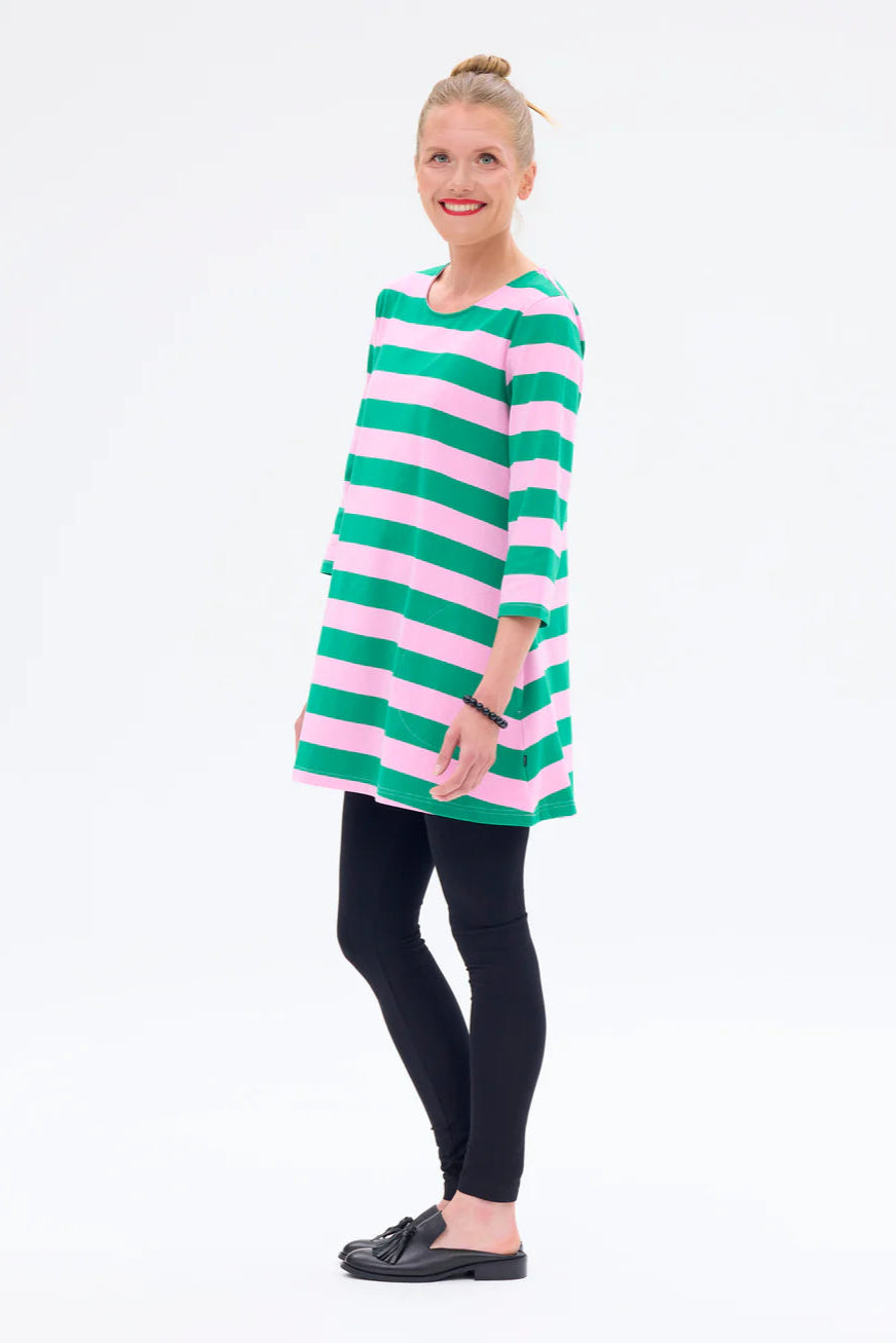 Woman wearing a green and pink striped dress on a white background