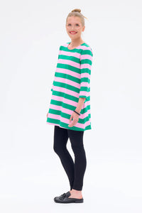 Woman wearing a green and pink striped dress on a white background