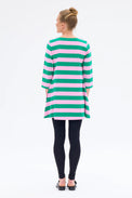 Person wearing a green and pink striped dress on a white background