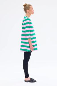 Woman wearing a green and pink striped dress on a white background