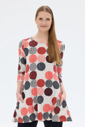 Woman wearing a polka dot dress with a white background
