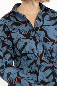 Close-up of a person wearing a patterned dress with blue and black design.
