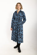 Woman wearing a blue patterned dress on a white background