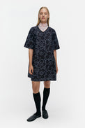 Woman wearing a patterned dress on a white background