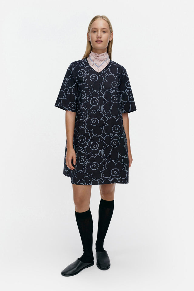 Woman wearing a patterned dress on a white background