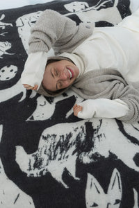 Person lying on a black and white patterned blanket